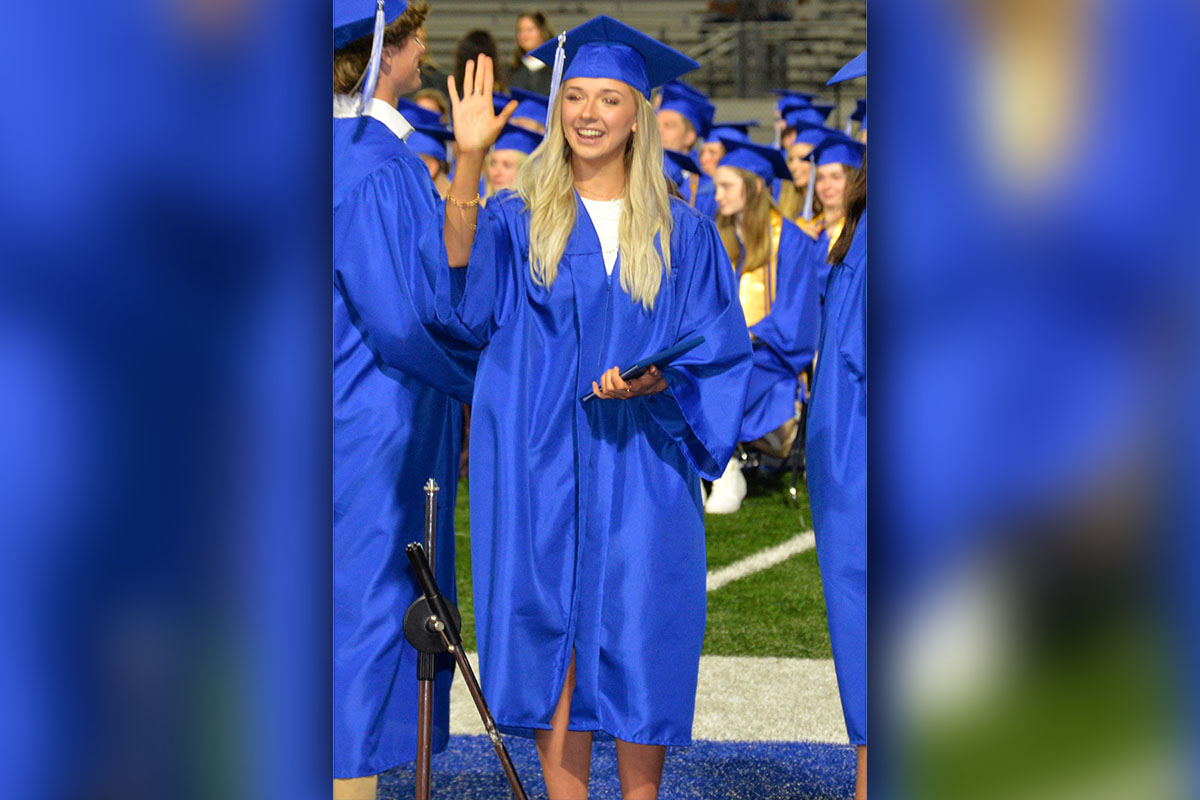 Hannah Sosebee smiles and waves after taking hold of her high school diploma Friday night at Fannin County High School.
