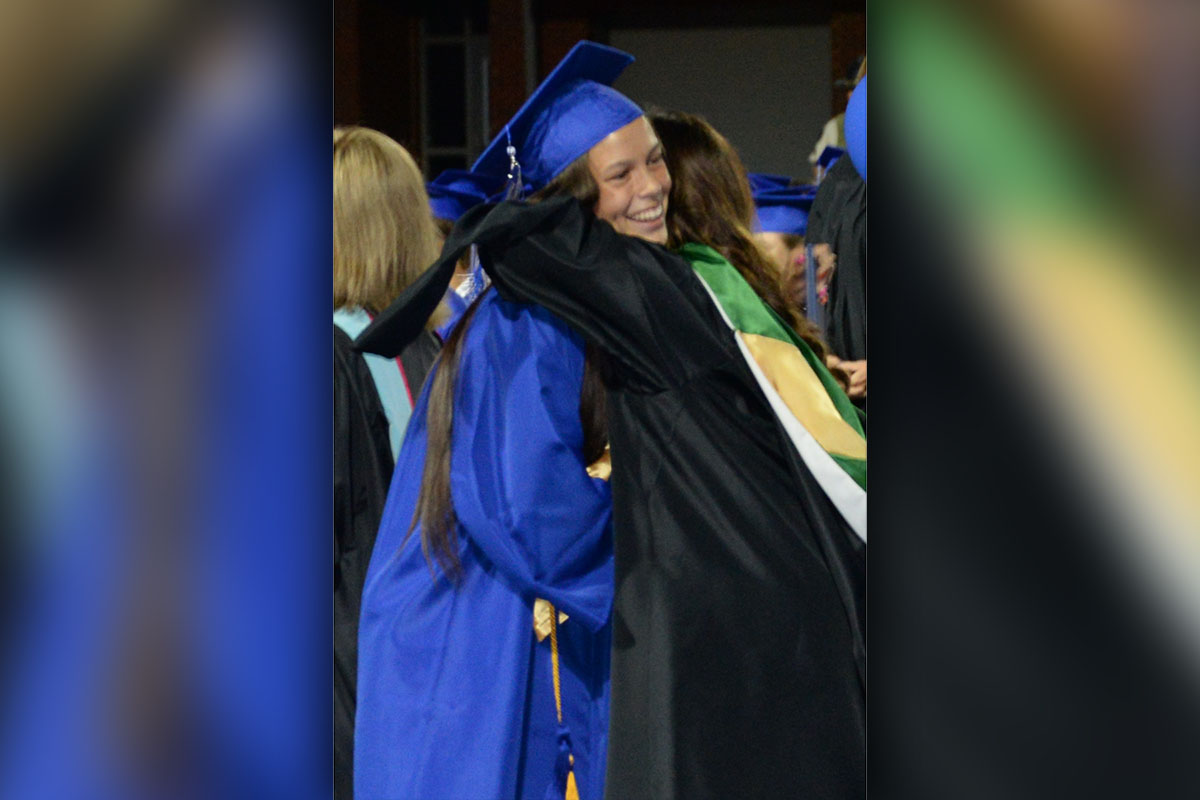 Madison Ponton gets a hug from Shannon York after receiving her high school diploma.