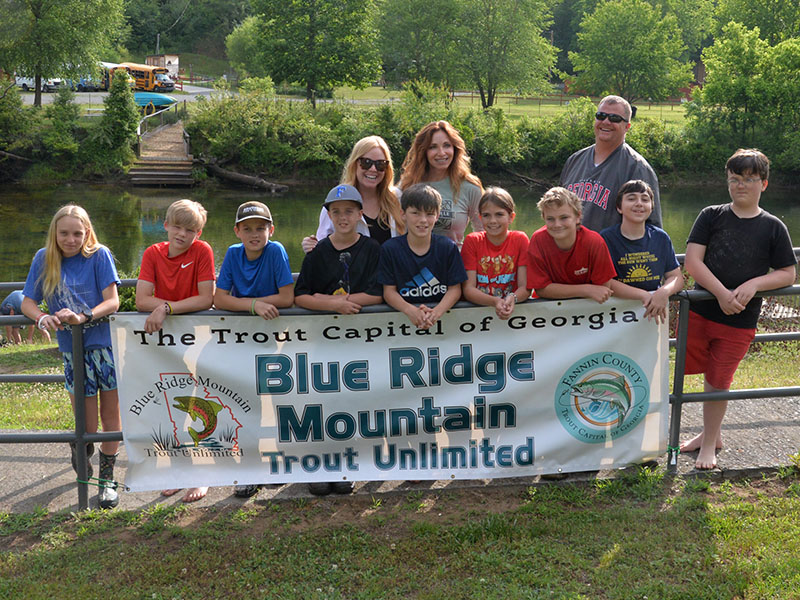 These Fannin County Middle School students, along with their teachers and assistant principal, released rainbow trout into the Toccoa River just before the end of school. Shown are, from left, front, Jacquelyn Cline, Kendrick Pack, Zane Perkins, Alex Ware, Alex Barber, Jayden Collins, Cash Ades, Corey O’Quinn, and Stewie Gustin; and, back, Exploratory teachers Tori Arp and Althea Gobble and Assistant Principal Matt Rosenberger.