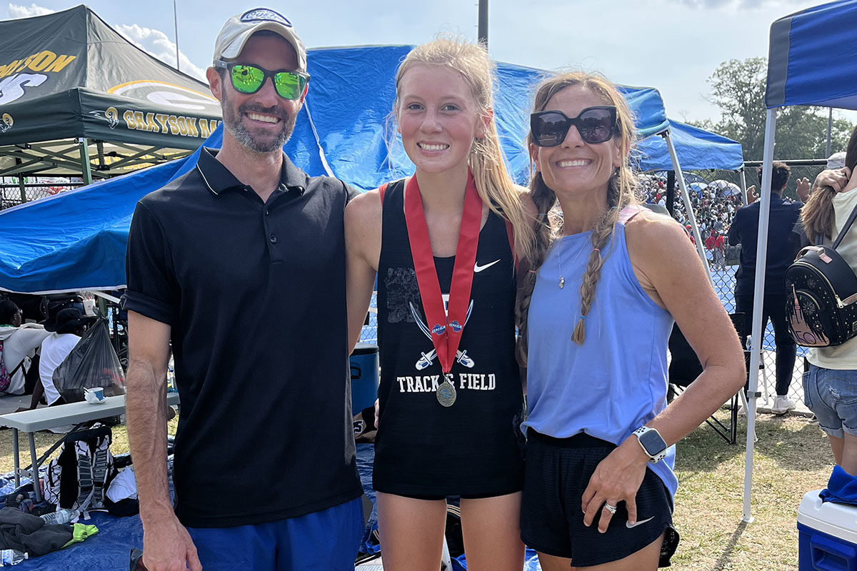 Sophomore Lindsey Holloway qualified for all four of the GHSA State Championship in her events and medaled in three out of the four. Shown are, from left, Mid/Long Distance Coach Lucas Roof, Lindsey Holloway, Head Coach Miranda Roof.