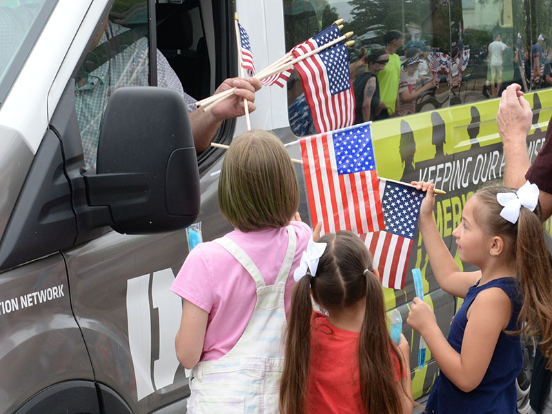 Children gather to receive free flags from Chapter 28 of the Disabled American Veterans.