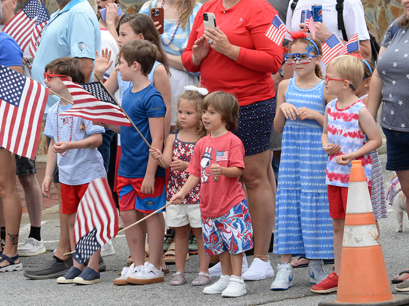 United States flags waved, left photo, as emergency equipment carrying a variety of riders made its way through the parade route in downtown Blue Ridge.