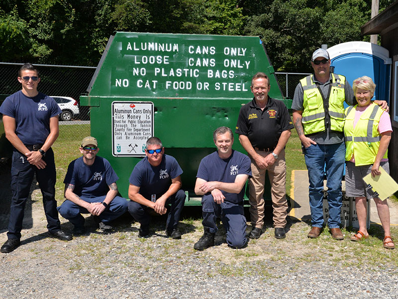 A partnership between the Fannin County Fire Department and WM that sees proceeds go to an education fund is continuing. Shown reminding citizens they can donate aluminum cans at the WM facility in Lakewood are, from left, Channing Johnstone, Michael Cornelius, Brad Beaver, Randy Epperson, Larry Thomas, Nathan Parris, and Charmell Mealer.