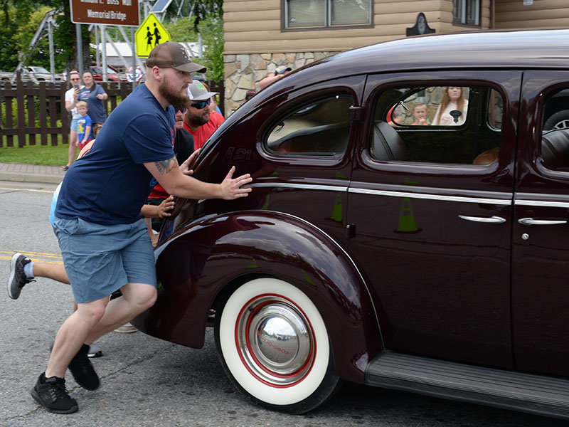 Parade watchers were eager to help when this antique car had engine trouble during the Independence Day parade in McCaysville.