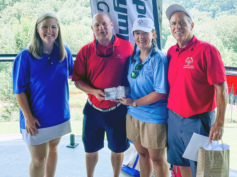 The Men’s Golf Association at Old Toccoa Farm hosted lunch for the Special Olympics golfers and also presented Special Olympics a donation at the end of the Golf Skills event. Shown during the check presentation are, from left, Gini Tipton, Men’s Golf Association President Jeff Lake, Jessica Ramirez, and Craig Hartman, who serves as director of golf for Special Olympics.