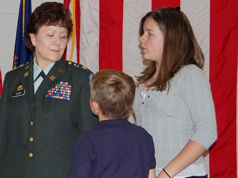 April King, who served in the Georgia Army National Guard as April Asher, is shown with her children, Christopher Asher and Taylor Asher, at her promotion ceremony to lieutenant colonel.