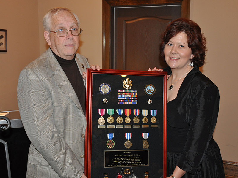 April King is shown with her father, Chief Warrant Officer 5 (retired) Robin James, at her retirement.