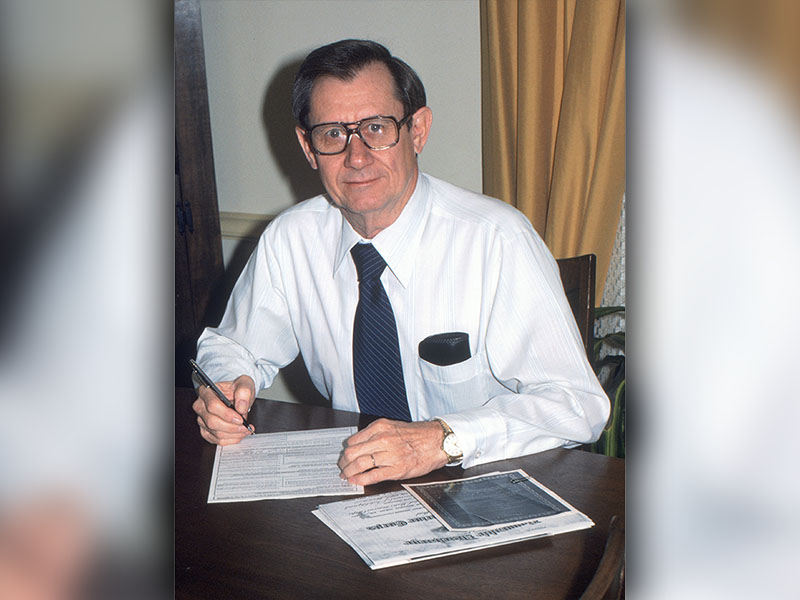 In 1980, Joel (Hatch) Hatchell retired from the Federal Aviation Administration. Pictured above, he signs his retirement paperwork. Hatch spent about 27 years working for the FAA.