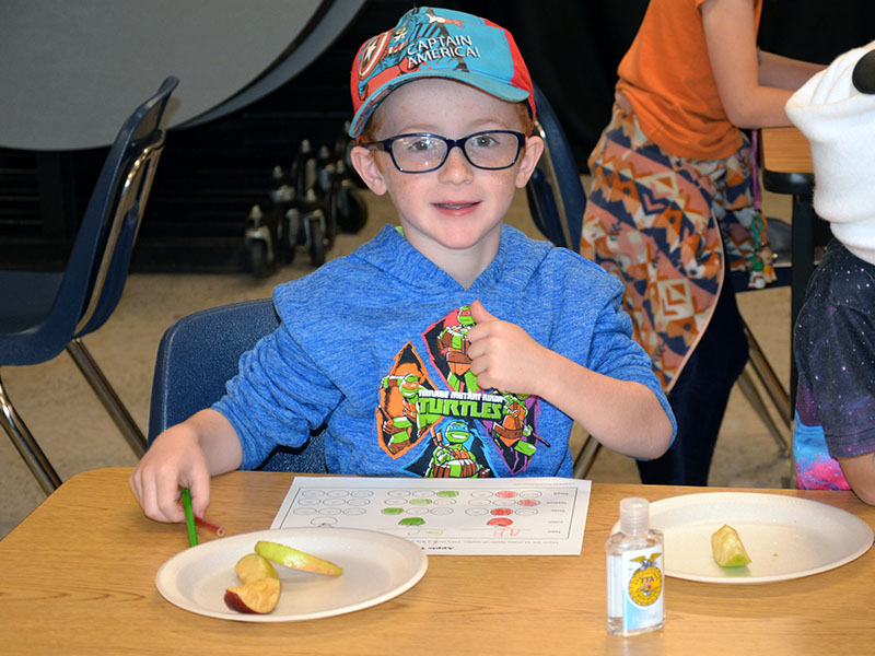First grader A.J. Ellis tries different types of apples.
