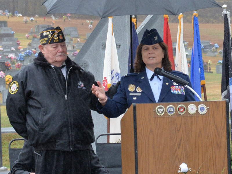 Gerald “Chief Mac” McMillan holds an umbrella to keep  retired Colonel Kathy L. Merritt dry as rain fell on the Veterans Day Ceremony Saturday in Blue Ridge.