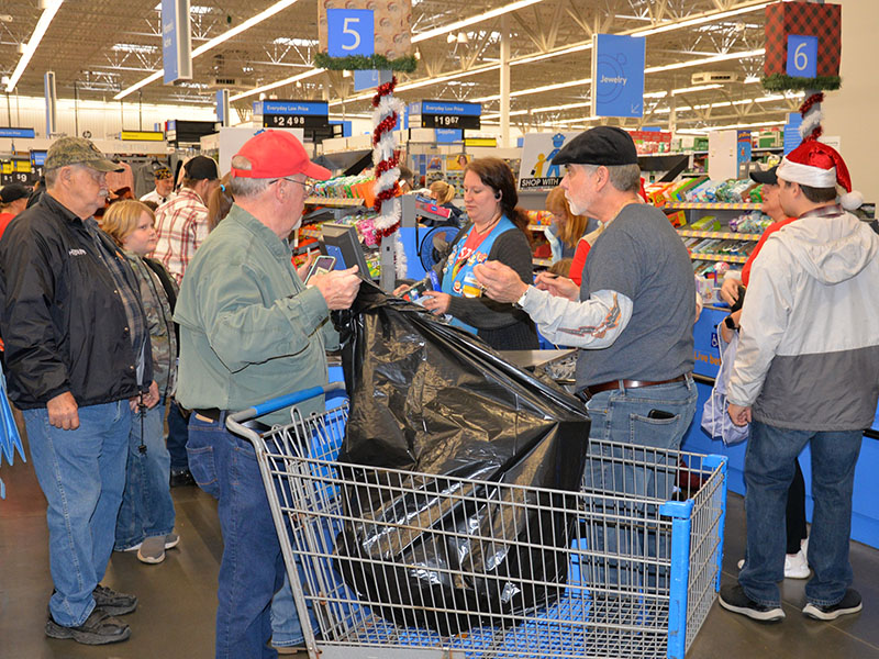 Bagging the toys and clothes purchased during Shop With A Cop was a full time job for several volunteers.