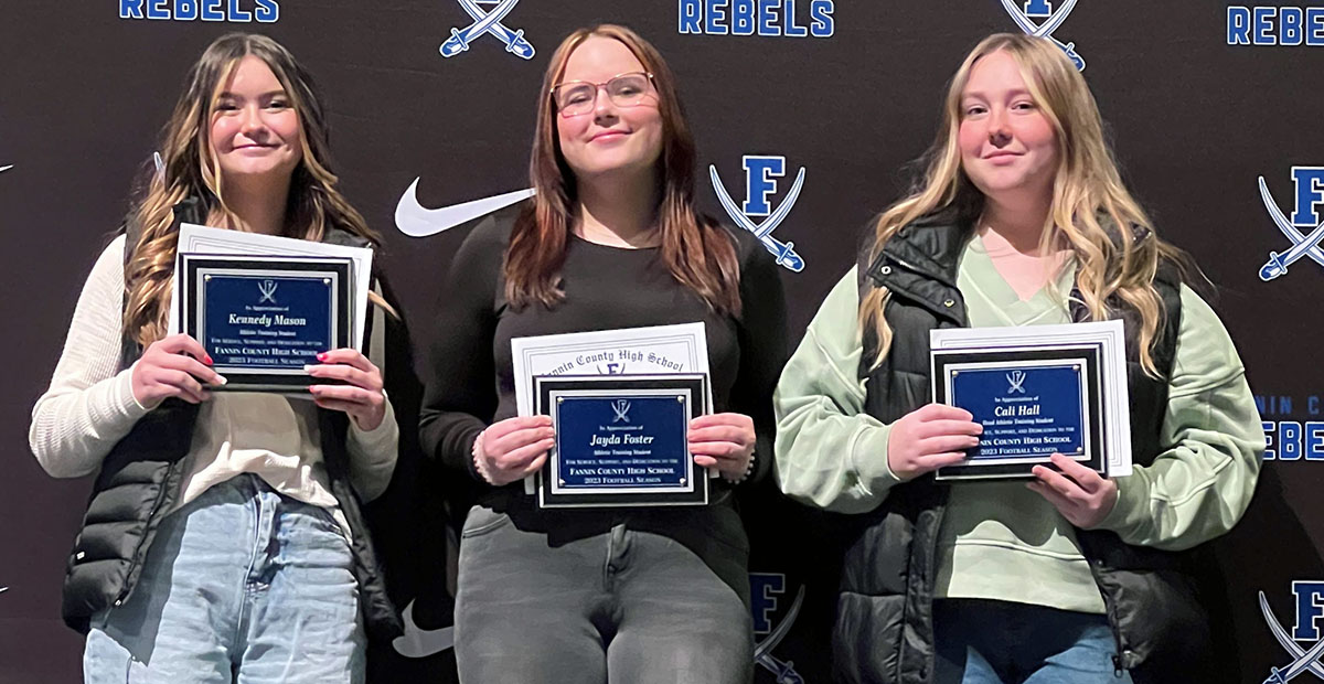 Kennedy Mason, Jayda Foster, and Cali Hall, from left, were recognized for their work as the football team’s trainers.