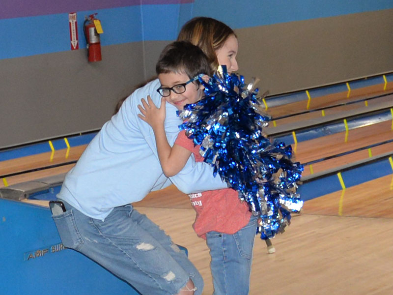 Carter Norton gets a big hug of congratulations from Fannin County High School cheerleader Kylah Imhoff at Special Olympics bowling. The annual event was held at Fannin Lanes in Blue Ridge Friday morning, February 23.