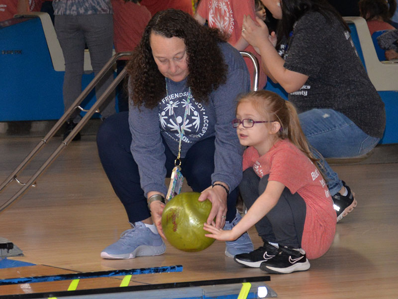 Kinsley Marlow of East Fannin Elementary gets a hand from Mrs. Jones as she lines up her next roll.