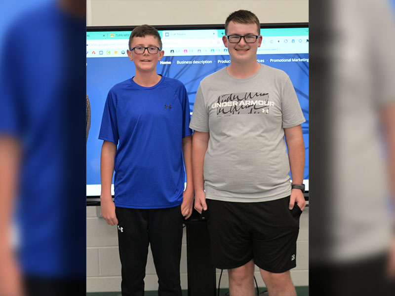 Hunter Pierce, left, and Cale Weeks won third place at the Fannin Count Middle School Shark Tank with their race car and side by side wrapping business.