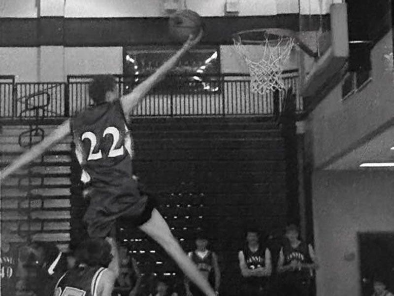 Seth McClure, jersey number 22, soars above the rim.