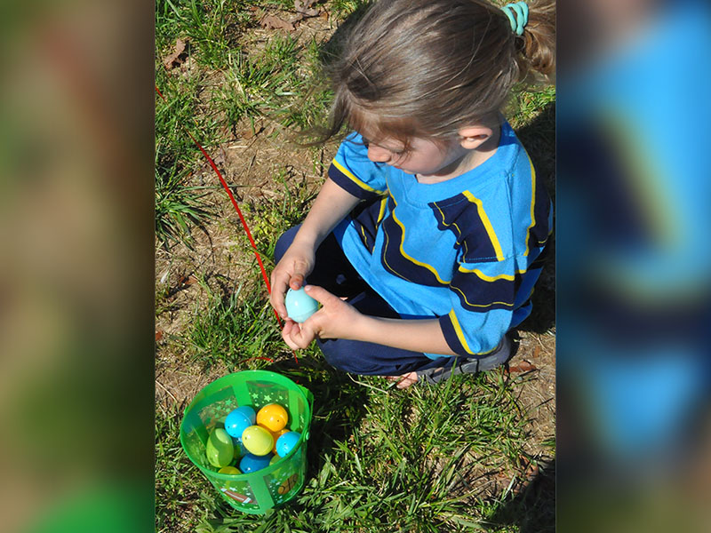 Sage Bennett sat down to relax after the egg hunt and checked each egg to see what was inside each one.