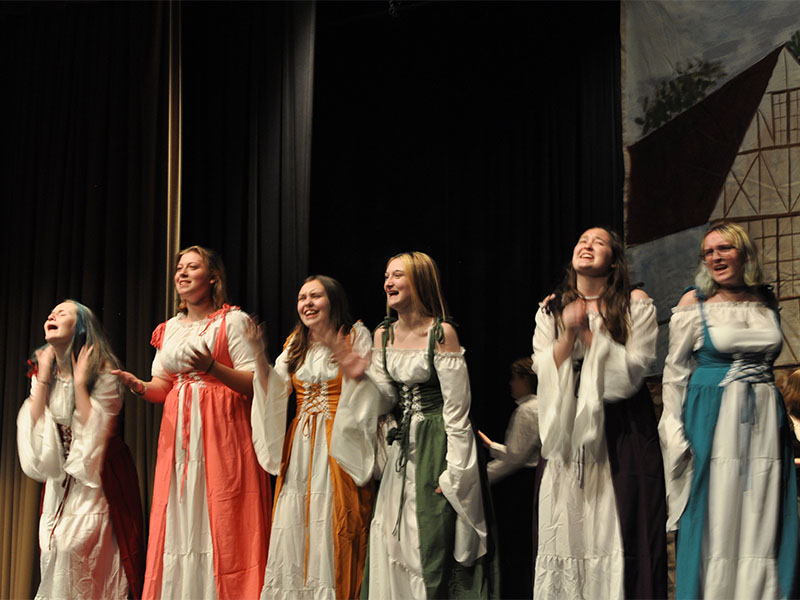 Cast members, from left, Elizabeth Oliver, Brooklynn Siler, Abigail Jackson, Gretchen McFarland, Emily Ableman, and Liliana Kenniff play women in the village swooning over Gaston in Beauty and the Beast.