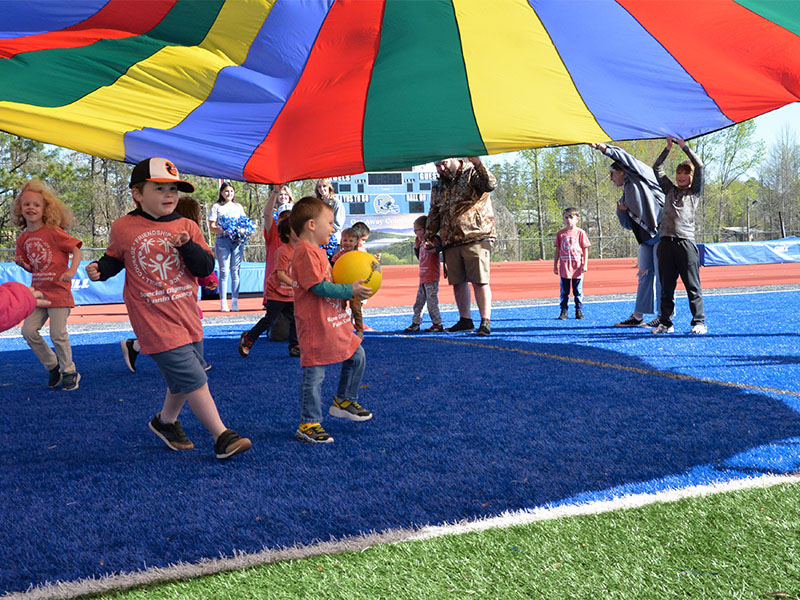 Fannin County Special Olympics Track and Field events returned to the Fannin County High School football field for the first time in seven years Friday morning, April 12, thanks to a day filled with sunshine. Pre-k and Kindergarten athletes from East Fannin Elementary School rush to get through the parachute roof before it comes down.