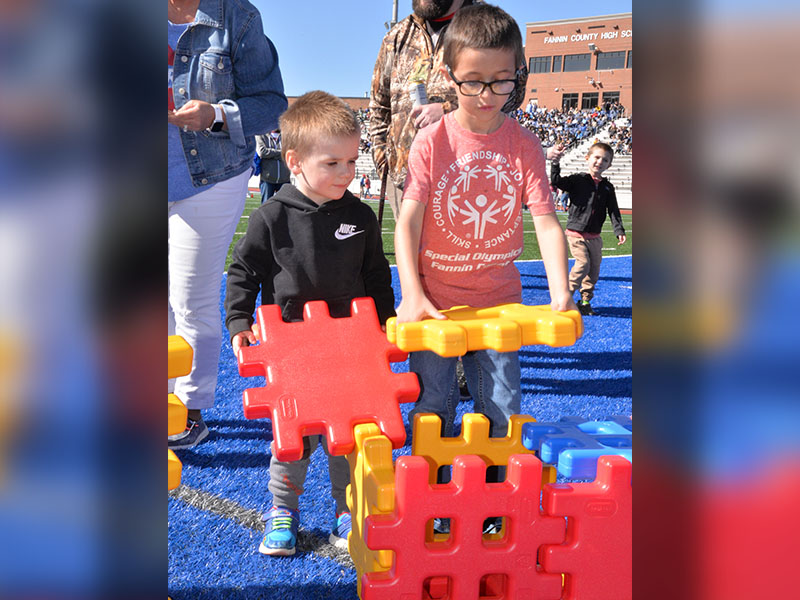 Carter, right, from East Fannin Kindergarten gets help with his construction project.