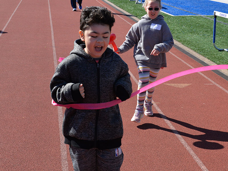 Nathaniel from Blue Ridge Elementary breaks the tape in the 50 yard dash.