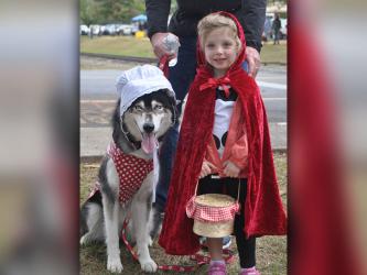 Little Red Riding Hood, Claire, and Big Bad Wolf, Mila, took a break and were all smiles during the annual Paws in the Park in downtown Blue Ridge, Saturday, October 19. Heavy rains didn’t dampen spirits for the annual event that included a parade and dock diving dogs.
