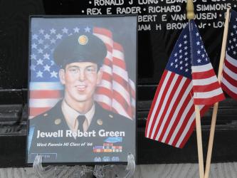 A photo of Jewell Robert Green and a United States Marine Corps coin were at the base of the Vietnam Memorial Traveling Wall Sunday, no doubt placed quietly by those who remembered sacrifices.