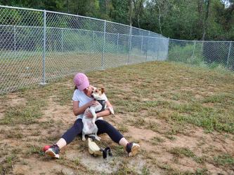 Fannin County Animal Control volunteer Debbie Williams spends time with one of the facility’s residents,“Rocco,” in Animal Control’s recently completed dog run.