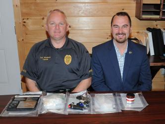 McCaysville Police Chief Michael Earley, right, and Detective Captain Billy Brackett are shown with 87 and a half grams of methamphetamine and assorted drug related objects confiscated during an arrest Thursday, October 31, at Mountain Lane Apartments.