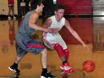 Evan Bobo tries to get around a defender in recent action for the Copper Basin Cougars basketball team.