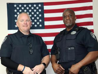 Fairmount Police Department Detective Billy Brackett, left, and Officer Mike Taylor were honored during a meeting of the city's council for turning a bad situation around and saving a life.