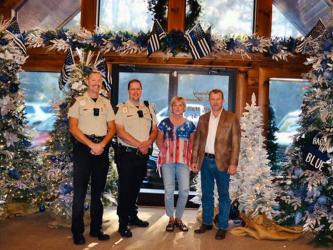 Folks have a chance to help local children through Fannin County’s Shop with a Cop program as Serenity in the Mountains has partnered with the program to host a Christmas Tour of Trees to raise funds. Shown are, from left, School Resource Officer (SRO), program organizer Lieutenant Darvin Couch, SRO Sergeant Jim Burrell, Serenity owner Lynda Cole and Sheriff Dane Kirby.