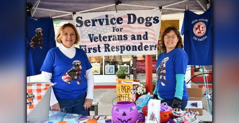 Pawsitive Action Volunteer Amy Ulrich, left, and Founder Norma Ross promote the non-profit’s mission to provide service dogs to veterans in the community during an event Saturday, October 31.
