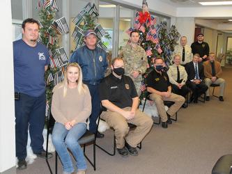 The staffs of Probate Court and Magistrate Court are honoring the county’s first responders and United States Armed Forces with a group of five special trees decorated on the second floor of the Fannin County Courthouse. Shown with the trees are, from left, seated, Victoria Weeks, EMA Deputy Director Patrick Cooke, Fire Chief Larry Thomas, Detention Center Captain Jill Huffman, Probate Judge Scott Kiker and Chief Magistrate Judge Brian Jones; and, standing, firefighters Bradley Beaver and Brad Beaver, U.S. 