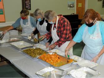 Pam Smith, Carolyn Howard, Sandy Daugherty and Kristi  Buchanan, from left, volunteered for the Good Samaritans's annual Open Table event, which was held Thanksgiving Day at the Fannin County Senior Center. This year the event had to be changed from the annual sit-down, festive occasion to a drive-thru offering. These volunteers were busy preparing plates for hungry participants.