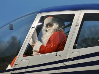 Santa Claus waves from the helicopter as he and pilot Damon Williams land at the Fannin County Recreation Department Wednesday, December 23. Santa made his appearance during a special drive-thru event. Due to COVID-19 restrictions, he wasn’t able to visit personally with children, but his appearance brightened many faces.