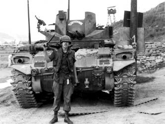 Army veteran Paul Hunter stands with a tank he worked on during the Vietnam War, which bears the inscription, “Executioner.” While Hunter worked on tanks, he also spent six and half months in an infantry unit.