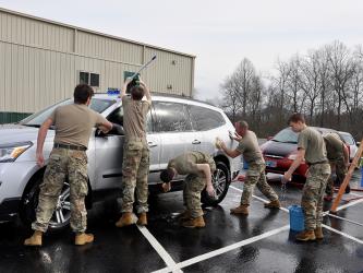 Mountain Area Christian Academy’s JROTC tackle a SUV during a car wash fundraiser Friday, March 12, to raise funds to visit Washington D.C., Arlington National Cemetery and the many war memorials there.
