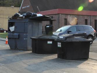 The garbage dumpster and two oil collection bins on Bridge Street will be moved to private property according to Karen Hawkins, who manages the three eateries in Riverwalk Shops.
