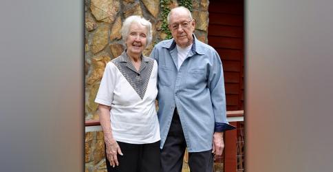 Mary and Peter Brown will celebrate 76 years of marriage April 20. They stand before the house they built together in Mineral Bluff.
