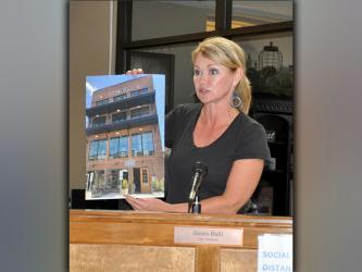 Councilwoman Rhonda Haight shows an image of a newer building that exceeds 35 feet in height during the Tuesday, March 30, town hall meeting.