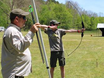 Boy Scouts of America troops from across North Georgia participated in a variety of outdoor activties when Fannin County's Troop 32 hosted their annual Highland Games Saturday, May 1, which included archery, caper tossing, hatchet tossing and stone throwing. Father and son duo, Tony and Stephen Young, of Troop 32, are shown at the archery competition station.