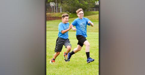 Reed Puckett, left, and Devon Hasker are all smiles Thursday, May 13, as they race themselves and peers during field day at West Fannin Elementary School.