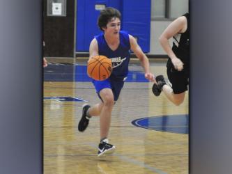 Will Jones pushes the ball up the floor in the Rebels basketball scrimmage with Gilmer County Wednesday, June 16.
