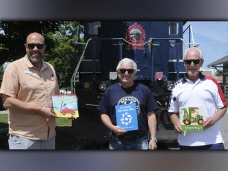 Kiwanis Club of Blue Ridge members Troy Shirbroun, Steven Miracle and club President Bill Echelberger hold examples of the books provided through Ferst Readers.