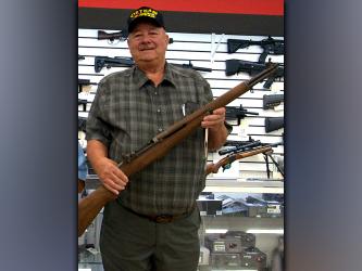 Disabled American Veterans (DAV) Commander Paul Hunter shows off the M1 Garand rifle the chapter is raffling to raise money. A .45 caliber Rock Island pistol is also being raffled. The DAV purchased both guns from McCaysville Drug & Gun. Chances to win the guns can be purchased at the veterans cookout Thursday.