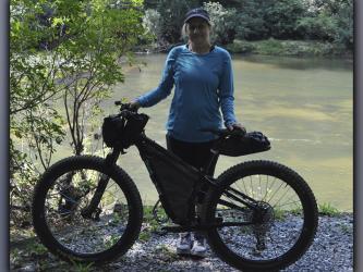 Linda Sledge poses with the bike that she used for the Trans North Georgia (TNGA) bikepacking adventure ride Friday, September 10. 