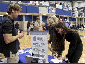 Senior Kenna Verner (left) and junior Hannah Perry (right) asked University of North Georgia Admissions Representative Barrett Rogers questions at the Probe College Fair held at Fannin County High School Friday, October 22. Students were able to speak with representatives from different colleges and universities. 