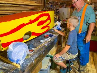 Seth Owenby and his grandpa, Steve Owenby work on their car for the Blue Ridge Soap Box Derby Fall Classic that took place Saturday, September 25.
