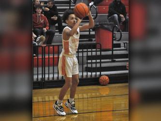 AJ Fitchett shoots a long range two-point basket during the Cougars game against the Bradley Knights Tuesday, December 14.